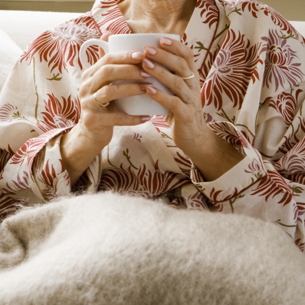 Woman on couch holding mug