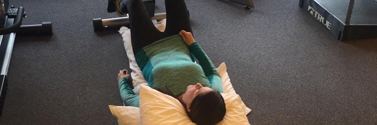 What an Average Workout Looks Like With Dysautonomia woman with pots lying on her back biking