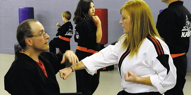 How Earning a Black Belt in Karate Changed My Life With a Disability Paul Brailer with a martial arts student.
