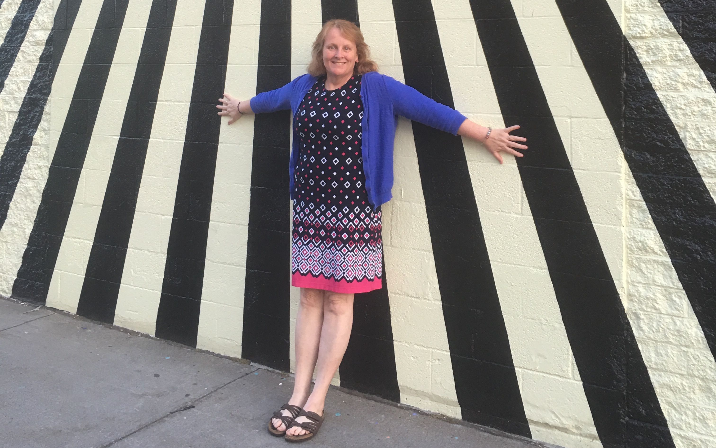 What People With Chronic Conditions Want Friends and Family to Know The author standing in front of a black and white striped wall