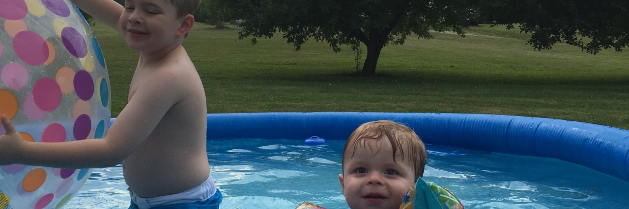 Samantha's two children in a pool.