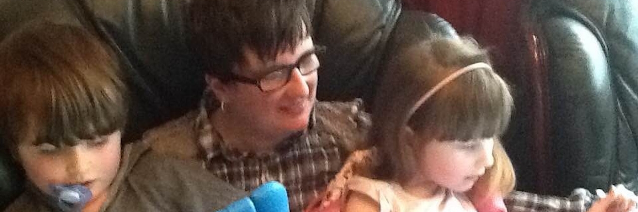 Advice for Special Needs Parents Who Don't Feel Like Enough mom reading to her two autistic children on ipads