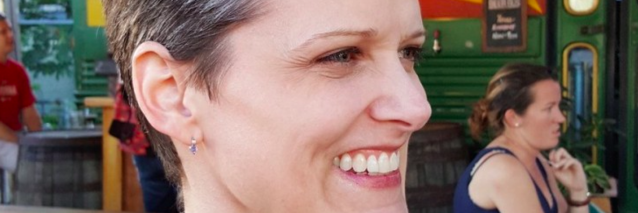 The One Thing I Want You to Remember Now That My Lupus Has Returned Contributor, a white woman with short brown hair, smiling and looking to the side