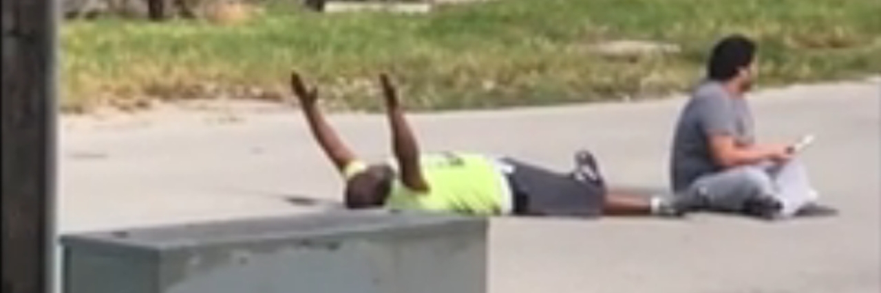 In video provided by Charles Kinsey's attorney, Kinsey lies on the ground with his hands up.