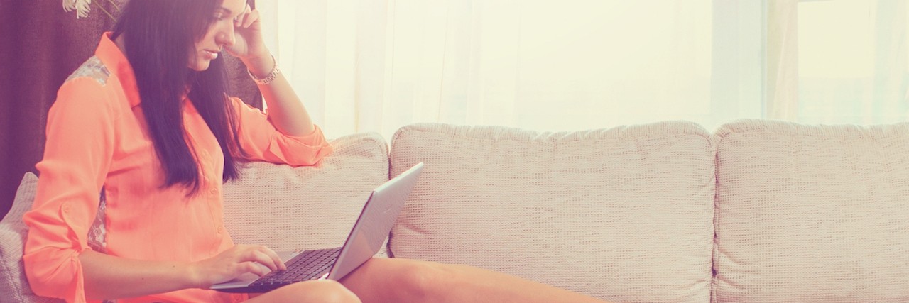 Response to Comparing and Negativity in Chronic Illness Social Media woman sitting on couch with laptop