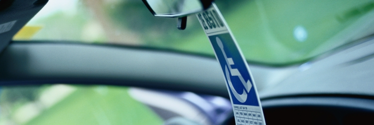 What to Know About Getting a Disability Parking Placard disabled parking pass on car mirror