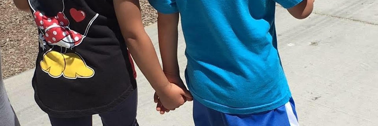 sister and brother holding hands