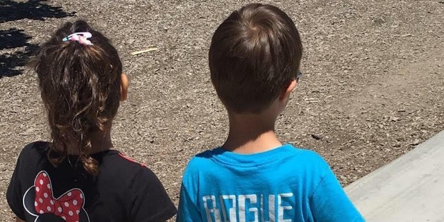 My Daughter's Response to a Hurtful Question About Her Big Brother With Down Syndrome sister and brother holding hands