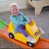 Courtney's daughter riding a toy car