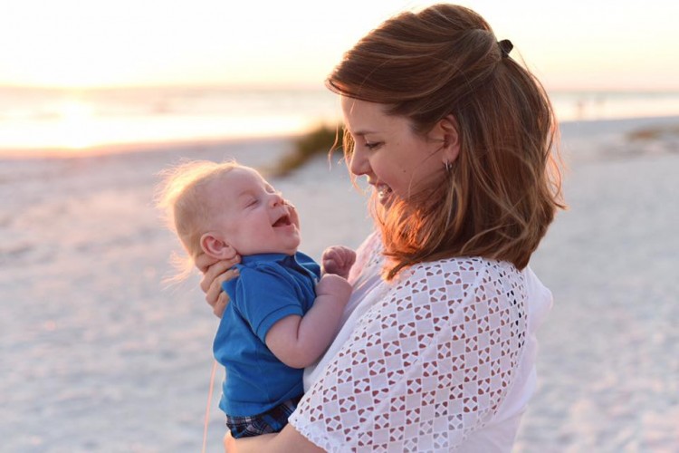 Natalie with her baby on the beach.