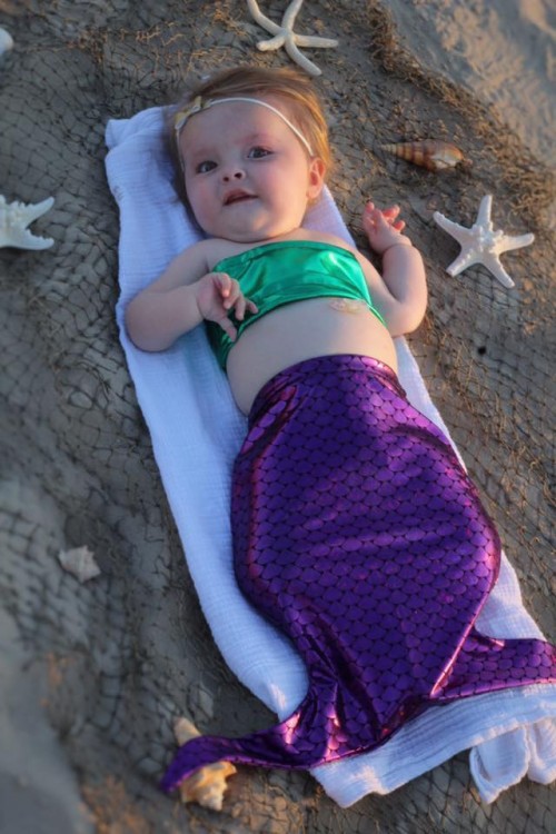 Daughter in mermaid suit with SMA