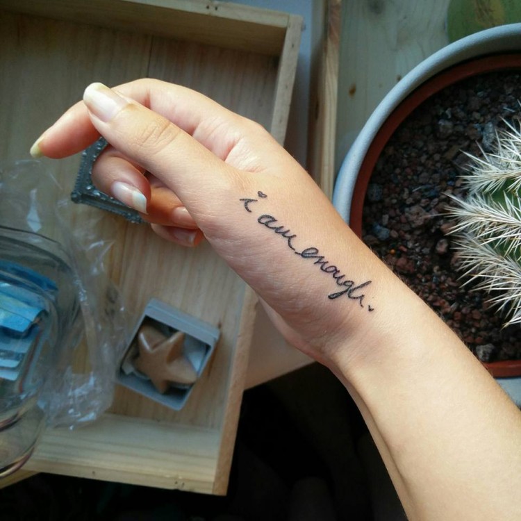 tattoo reads: "I am enough."