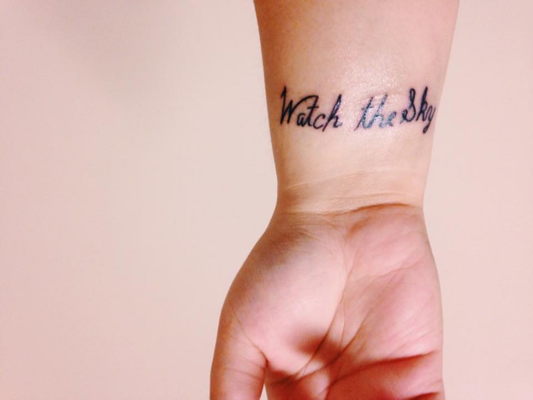 tattoo that reads watch the sky