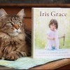 Thula the cat poses with a copy of Arabella Carter-Johnson's new book "Iris Grace."
