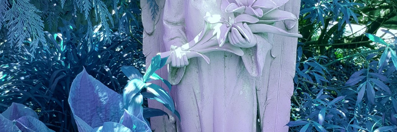 Managing Grief After Losing Son to Ewing Sarcoma small angel statue in a garden