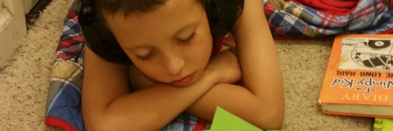 On Acceptance and Unconditional Love of Autistic Children little boy doing his homework