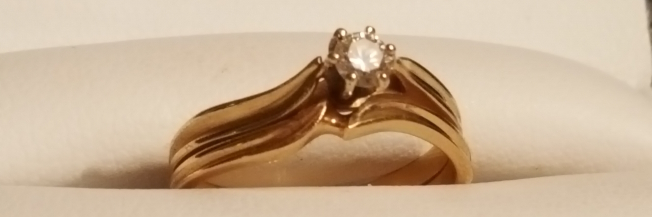 gold engagement ring with diamond in center