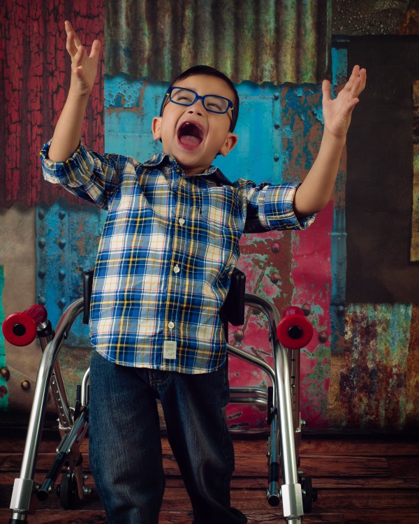 Young boy posing with his mobility device