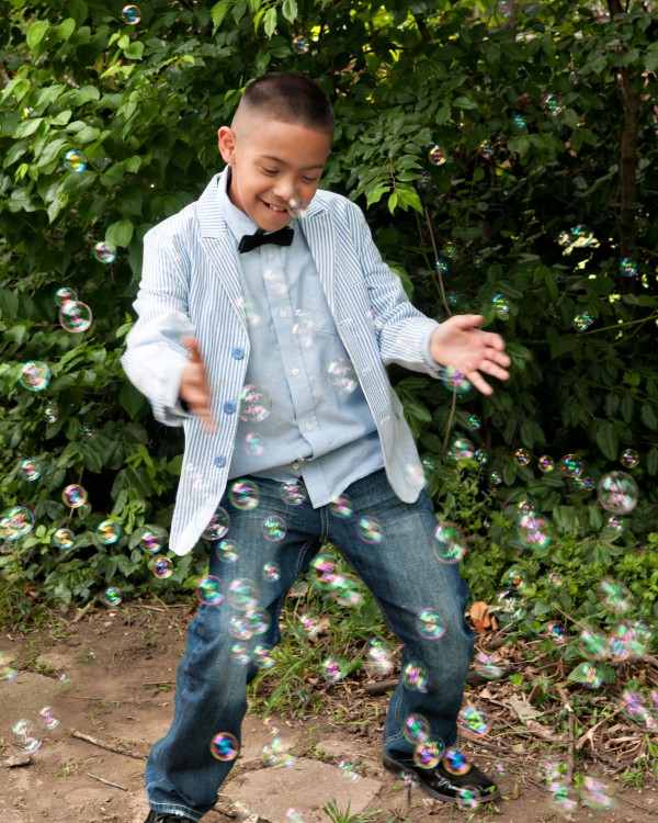 Young boy posing with bubbles