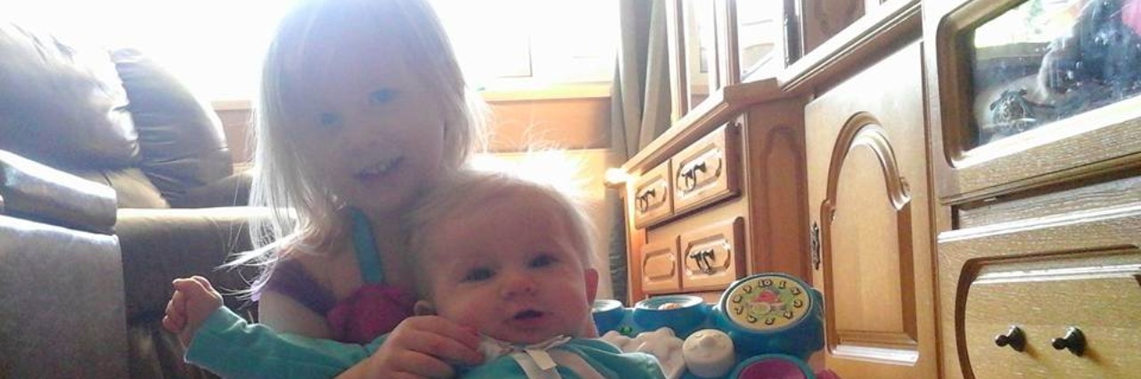 Special Needs Parenting: Sharing Time Between Children Charlie and Laura smiling.