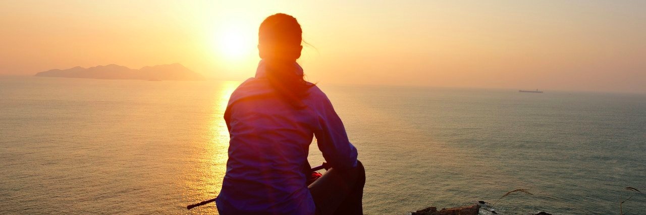 woman hiker watching the sunrise