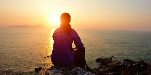 woman hiker watching the sunrise