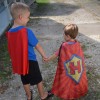 two boys in capes