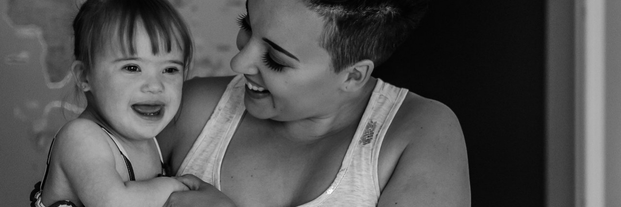 Secrets of My Life as a Mom of a Child With Down Syndrome Black and white photo of mom holding her daughter