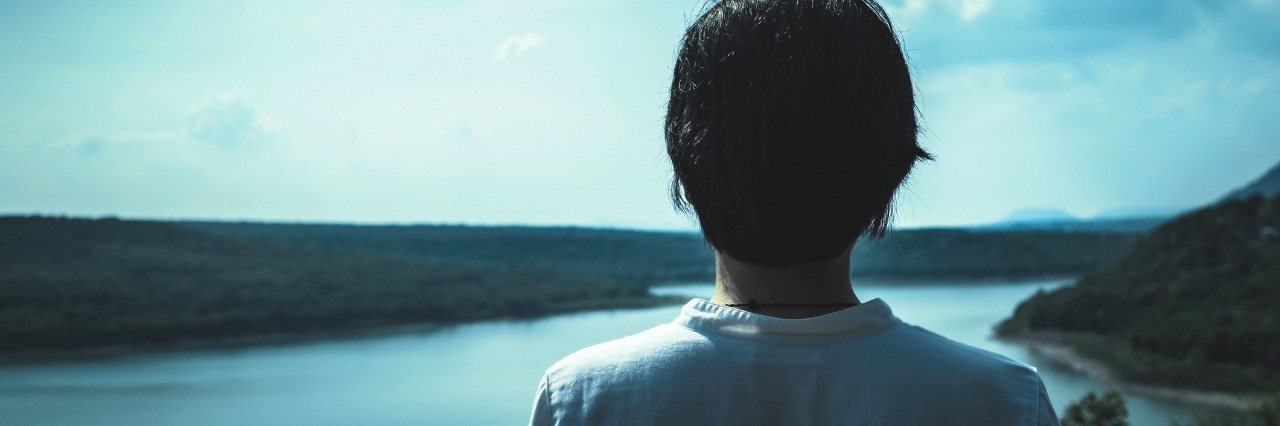 Tips for Talking to Someone With a Chronic Illness young woman standing on top of a mountain