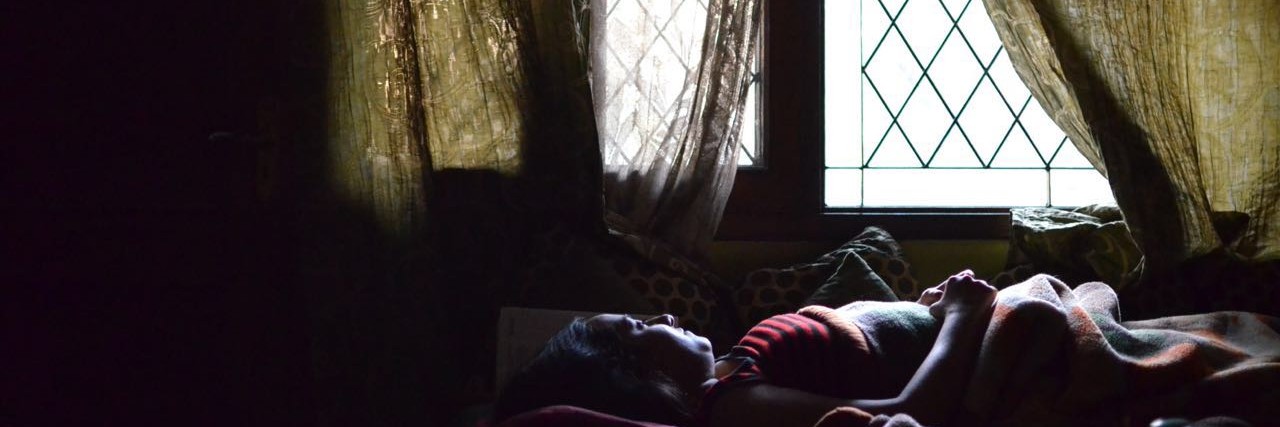 Letter for Depressed People Thinking About Suicide woman laying on bed near window