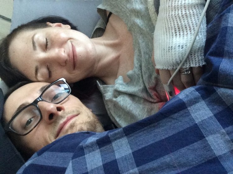 man and woman in hospital bed under blanket