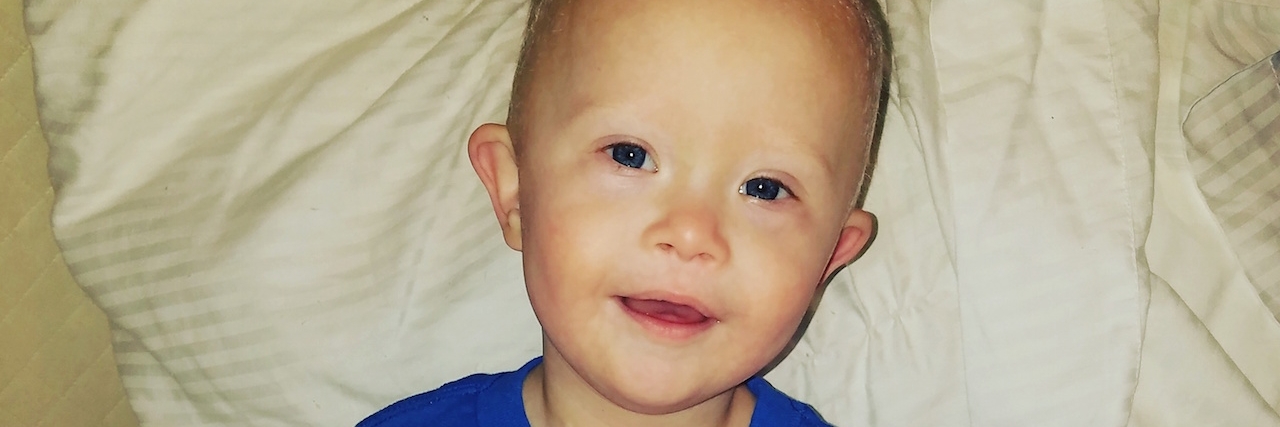 When a Woman Said ‘At Least You Can’t Tell’ My Son Has Down Syndrome The author's son wearing a blue shirt