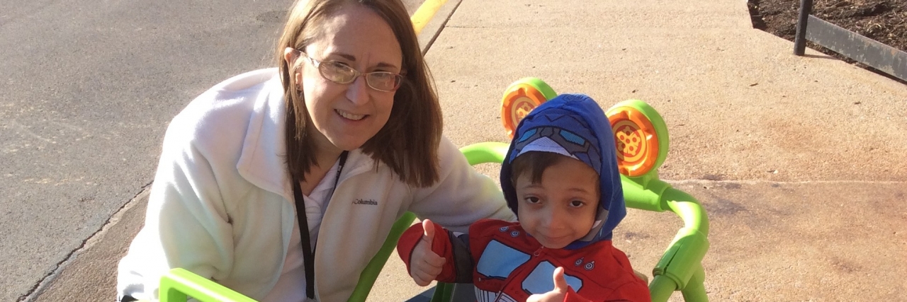 Seeking Help at School With Jansen’s Metaphyseal Chondrodysplasia Arshaan with his physical therapist in a jeep she made outside