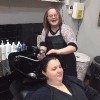 Jenna washing a client's hair