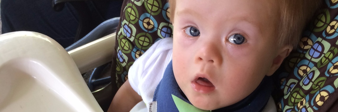 Finding Out a Baby Has Down Syndrome: The Unspoken 'Oh' baby with down syndrome in a high chair