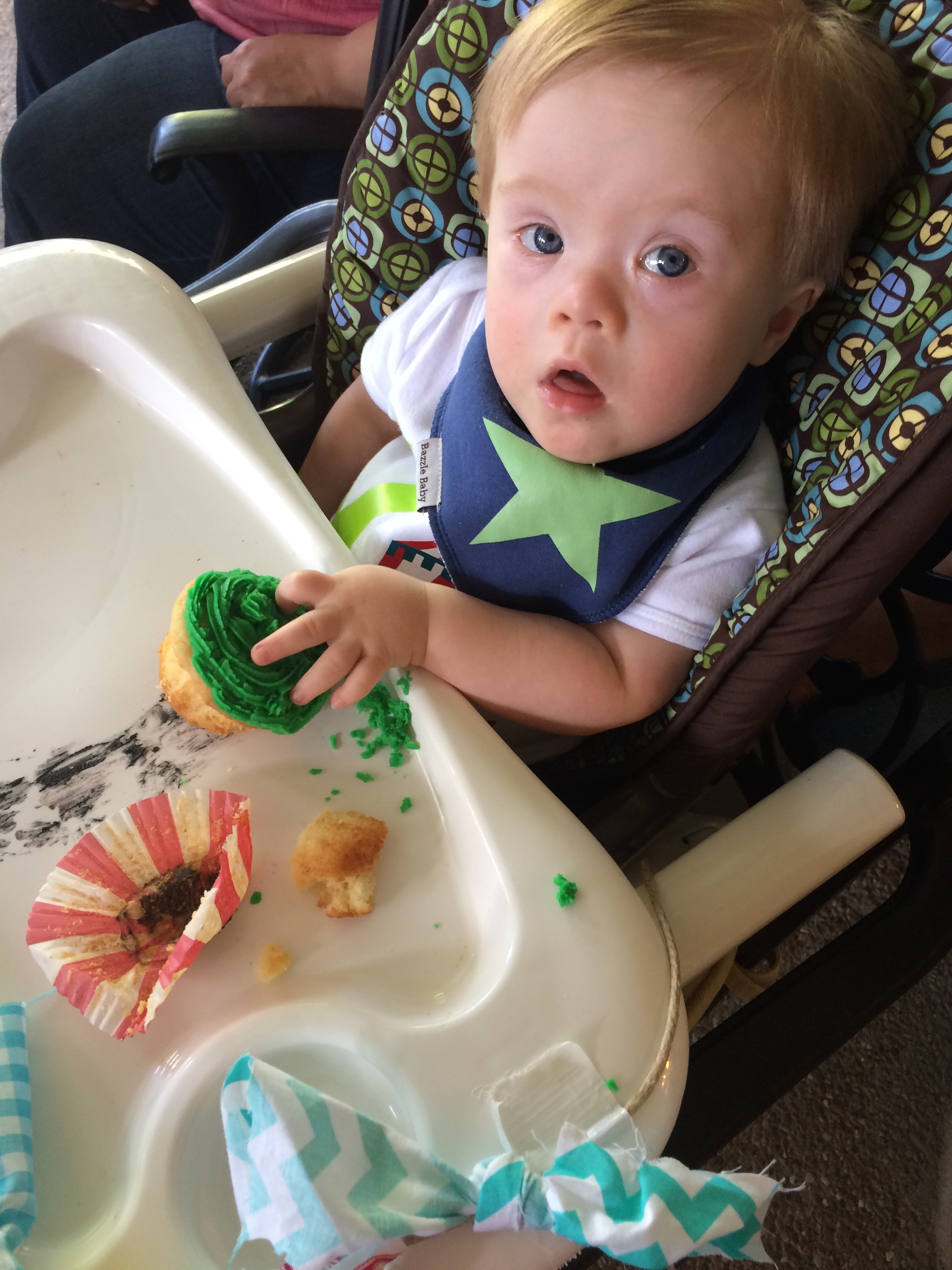 baby with down syndrome in a high chair
