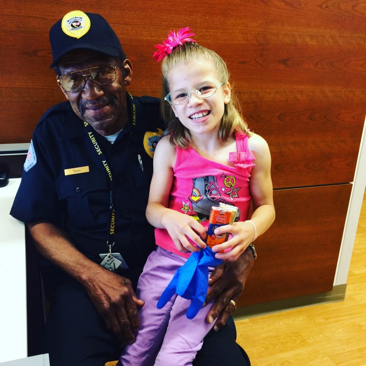 hospital security guard with little girl on lap