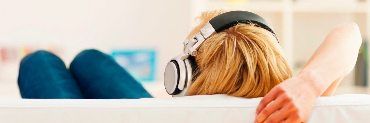 Song Captures How My Chronic Illness Makes Me Feel woman listening to music on headphones
