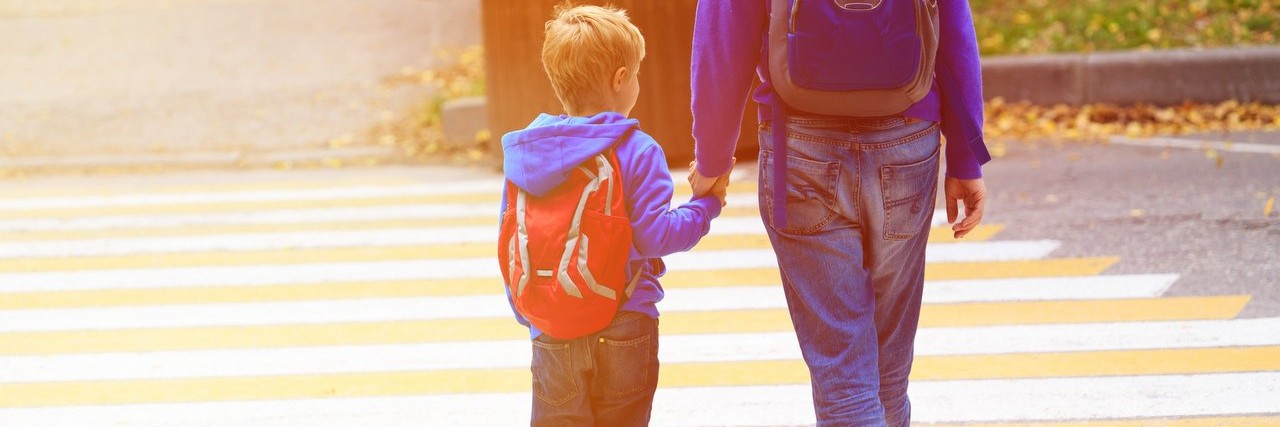 Ways to Create Ease About the New School Year for a Child With Autism parent walking son to school