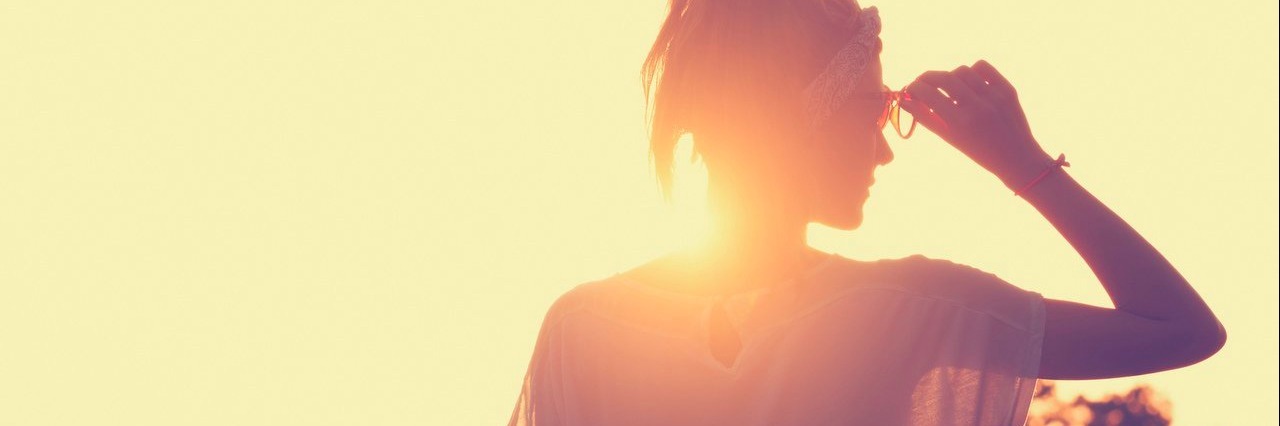 Chronic Illness: Being Honest With Myself About My Health woman looking at the sunset