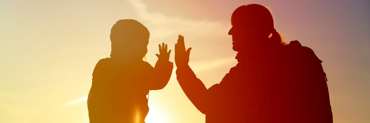 Important Lessons My Son’s Crohn's Diagnosis Taught Me mother and child travel at sunset