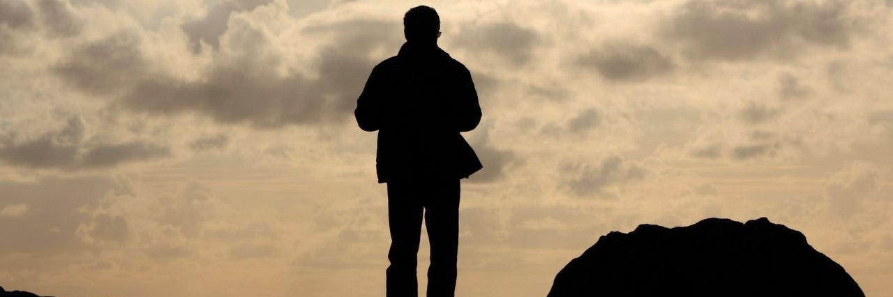 Autism: When People Say I’ve ‘Outgrown’ My Diagnosis man on a cliff watching the sea