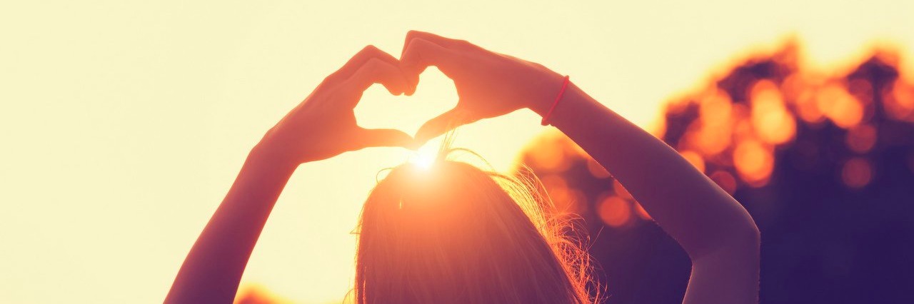 Wishes From the Heart of Someone Who Stutters woman forms a heart with her fingers