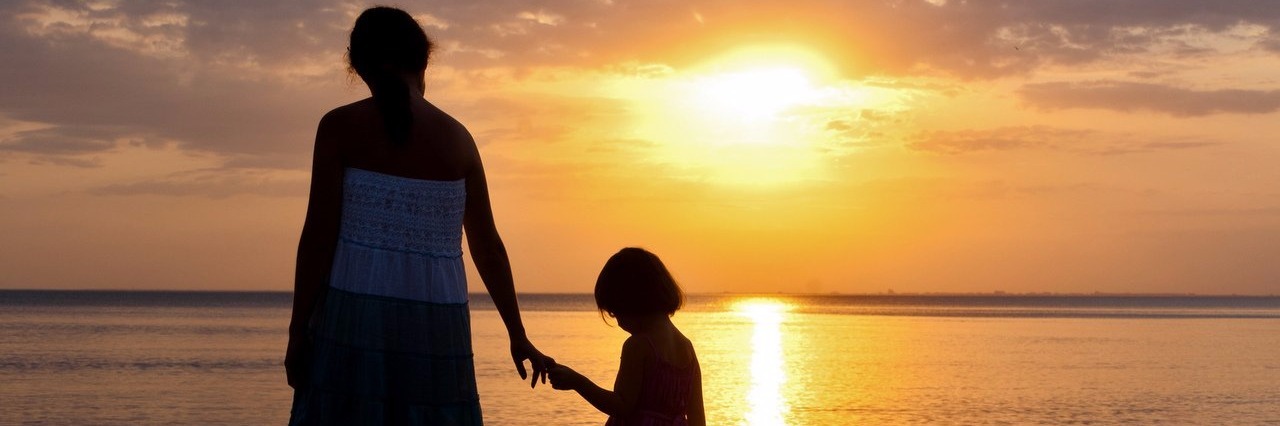 My Child With Autism and I Have Arrived in a ‘New Land’ mother and daughter walking on the beach during sunset