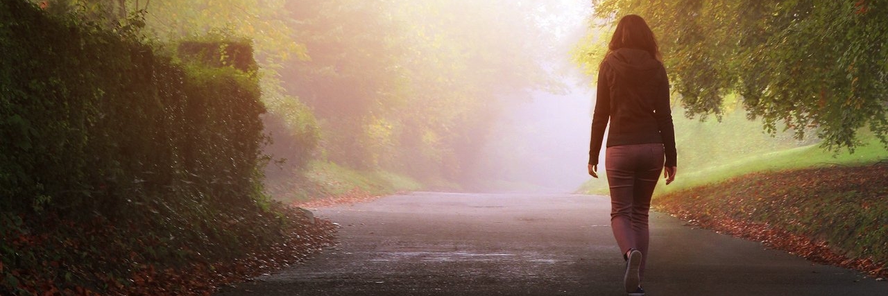 I Haven’t Forgotten You Just Because of My Chronic Illnesses woman walking alone on a misty day