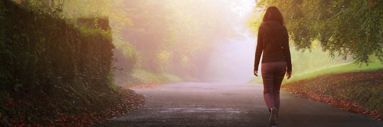 woman walking alone on a misty day