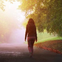 woman walking alone on a misty day
