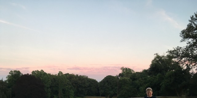 A young boy plaing Pokemon Go on his phone in a park