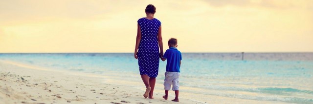 mother and son walking on the beach