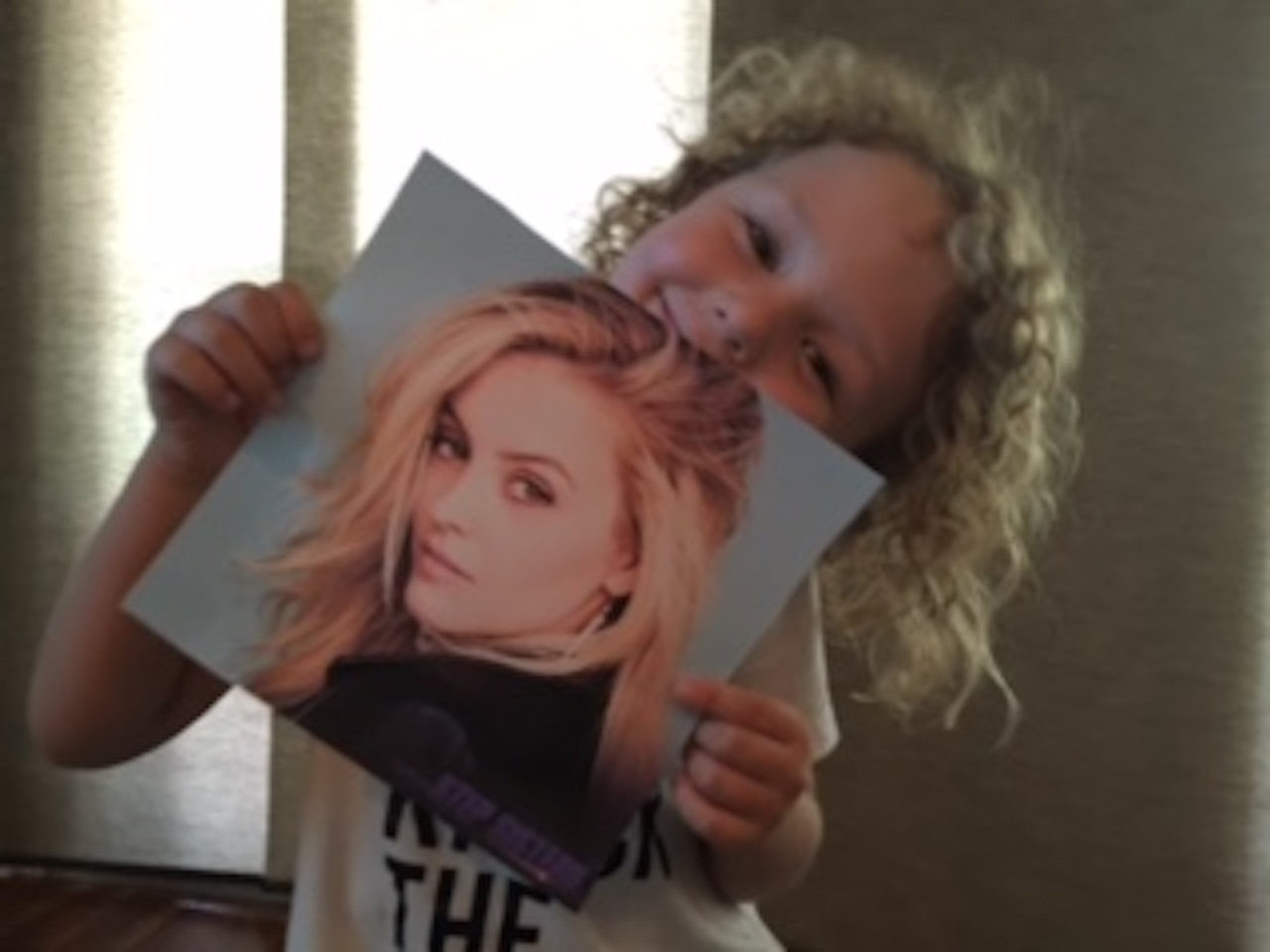 little boy with apraxia holding photo of gage golightly